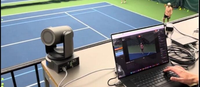 Elevated PTZ cameras on balcony area for tennis match.