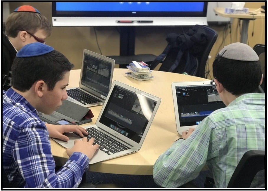 SAR High School Broadcast Club works on editing sports video footage. 